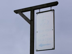 Faded signpost for the Swan Inn Wilton
